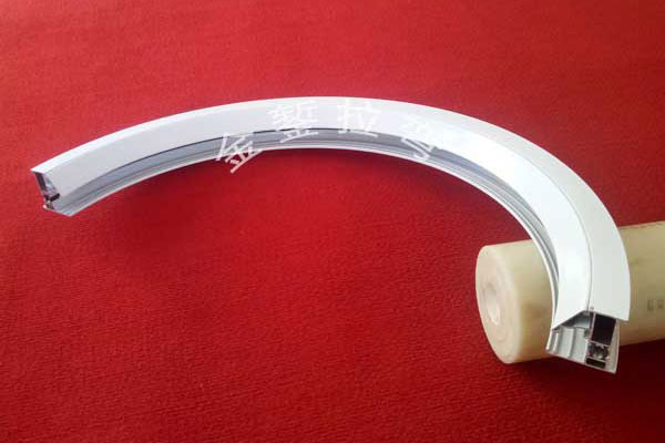 Stretch Bending of Upward-Arched Circular Triangular Trim Strips