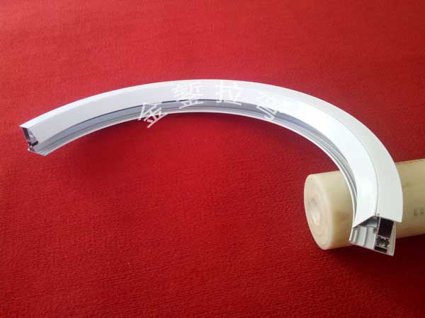 Stretch Bending of Upward-Arched Circular Triangular Trim Strips